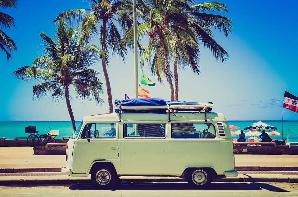 VW camper parked on the beach